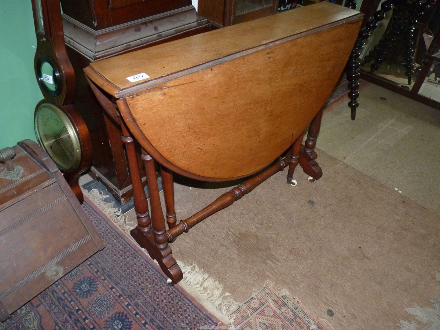 A circa 1900 Satinwood Sutherland type Table standing on turned supports and stretchers and being