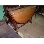 A circa 1900 Satinwood Sutherland type Table standing on turned supports and stretchers and being