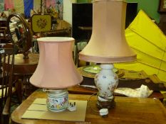 A Poole Pottery table lamp and a floral table lamp, both with pink shades,