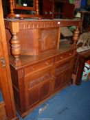 A Priory Oak style reproduction Court Cupboard having toggle door latches,