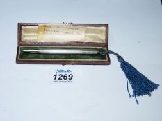 A silver propelling pencil, hallmarks for Birmingham, with blue tassel and with case.