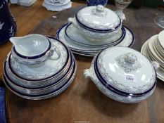 A quantity of dinnerware with blue rims with silver coloured swags including graduated meat plates,