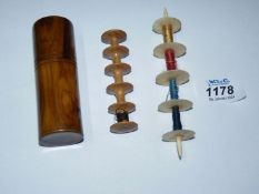 Two 19th century multiple spool holders, one of bone the other of wood in a case.