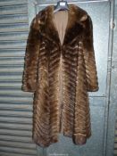 A ladies fur and leather Coat in chevron pattern with brown embroidered lining (original cost £5,