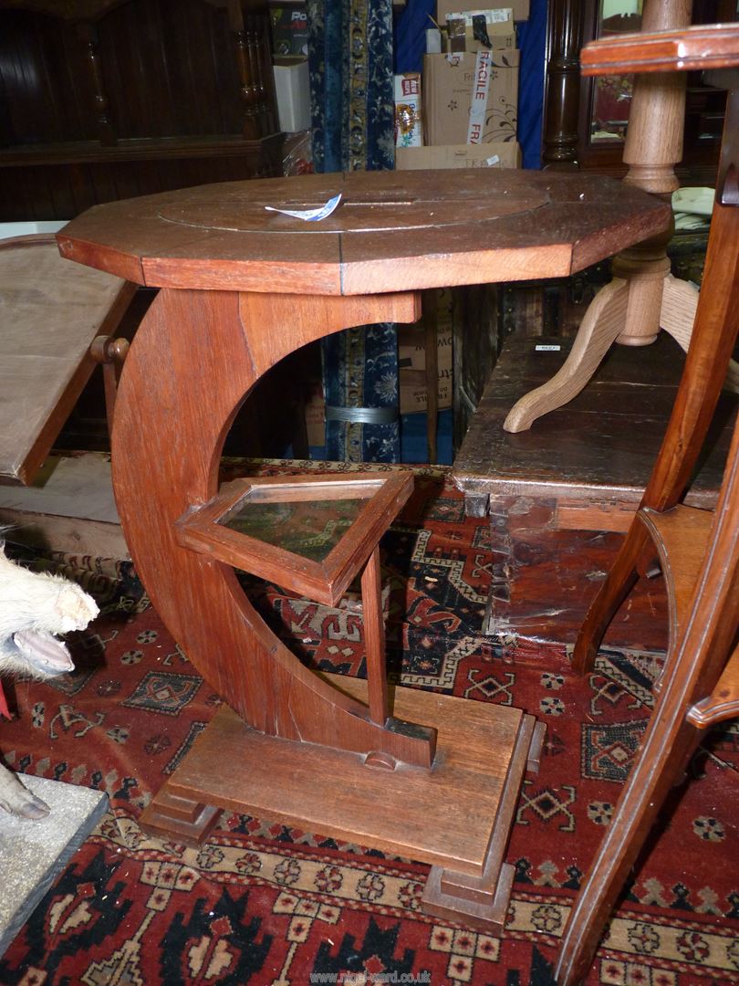 An unusual arts and crafts occasional Table having an oval ten sided crossbanded top,