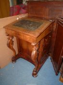 A mixed woods Davenport, the tooled lined shape lifting to reveal an interior with four drawers,
