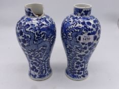 A pair of blue and white oriental vases having four claw dragons and foliate pattern,