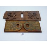 Two book slides including one with brass detail, the other with applied wooden floral carvings,