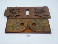 Two book slides including one with brass detail, the other with applied wooden floral carvings,