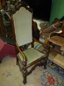 An elegant darkwood framed Hall Armchair with canted front legs united by an arched stretcher and