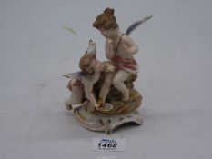A small delicate figure of two winged Cherubs,