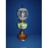 An oil lamp with ceramic base, brass column,