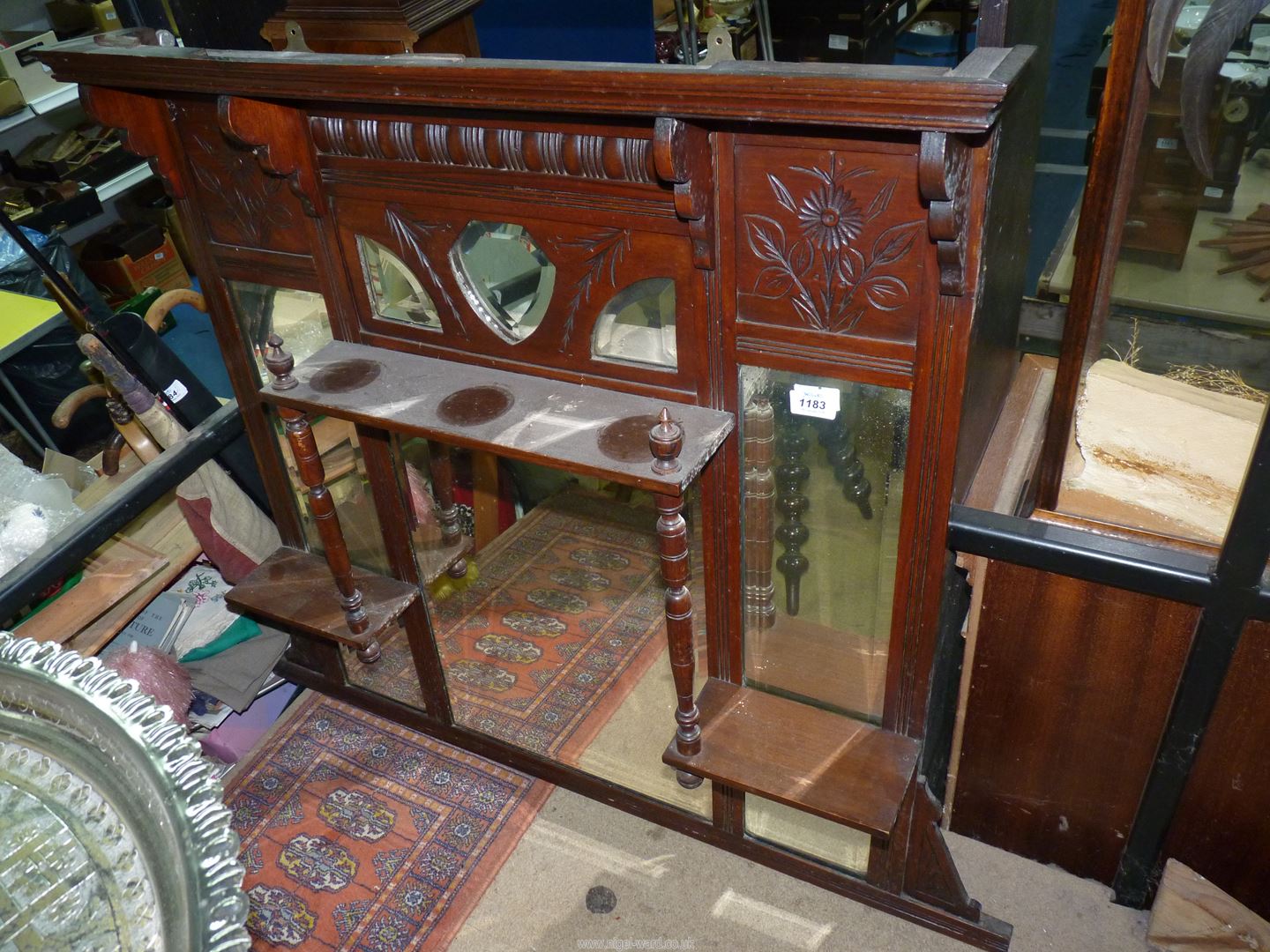 A Mahogany over mantel Mirror having multiple bevelled mirrors and a shelf with turned supports,