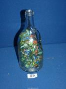 A glass bottle of marbles.