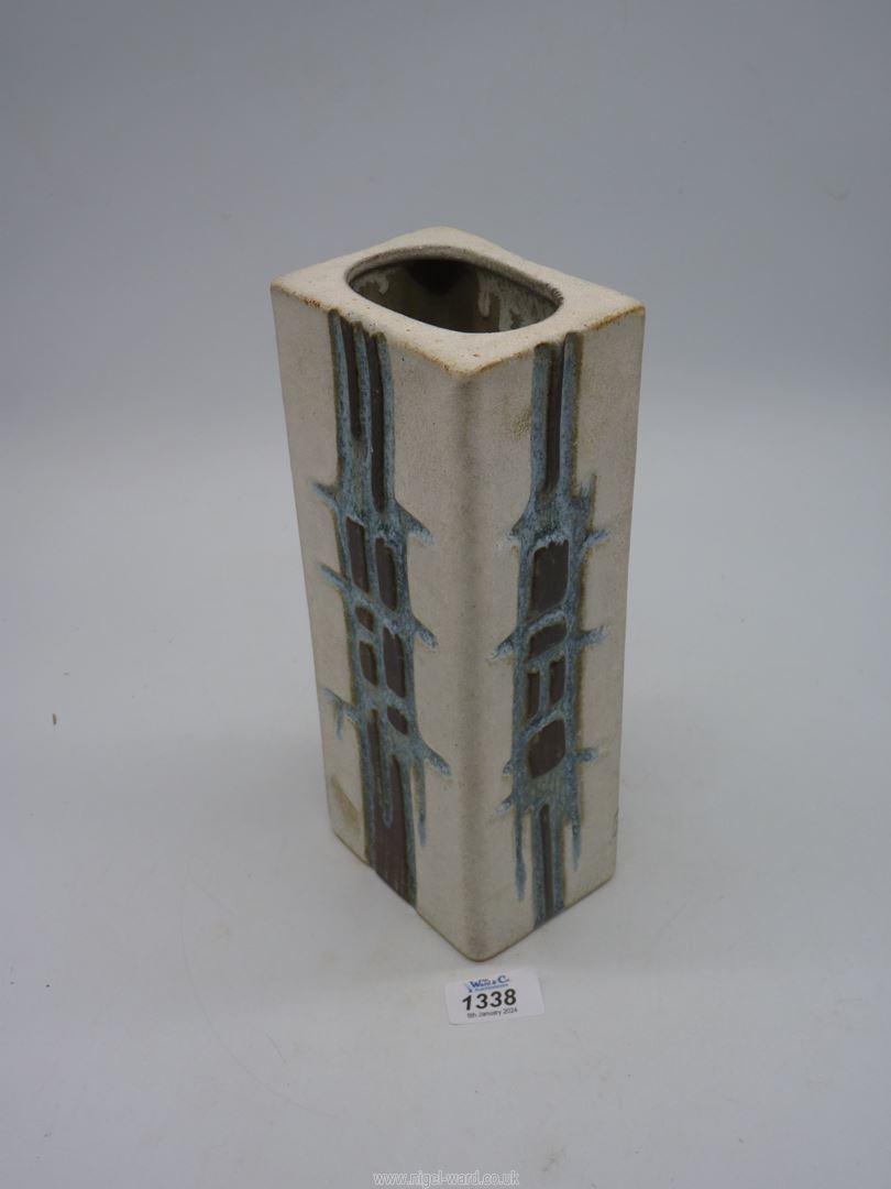 A Cornish Tolcarne pottery vase in square shape with blue and brown geometric pattern on a white