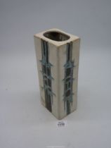 A Cornish Tolcarne pottery vase in square shape with blue and brown geometric pattern on a white