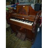 A mixed woods 4 1/2 octave Harmonium of arts and craft design with fretwork decoration,