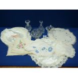 Two embroidered linen table mats, plus a 'Galway 24% lead crystal' bottle, and flower scent bottle,