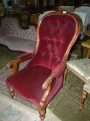 A circa 1900 Mahogany/Satinwood framed buttoned back open armed Armchair standing on turned front