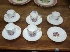 Five Royal Worcester coffee cans and six saucers in floral spray pattern.