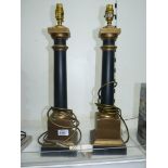 A pair of table Lamp bases with smooth black columns on gold coloured square bases and