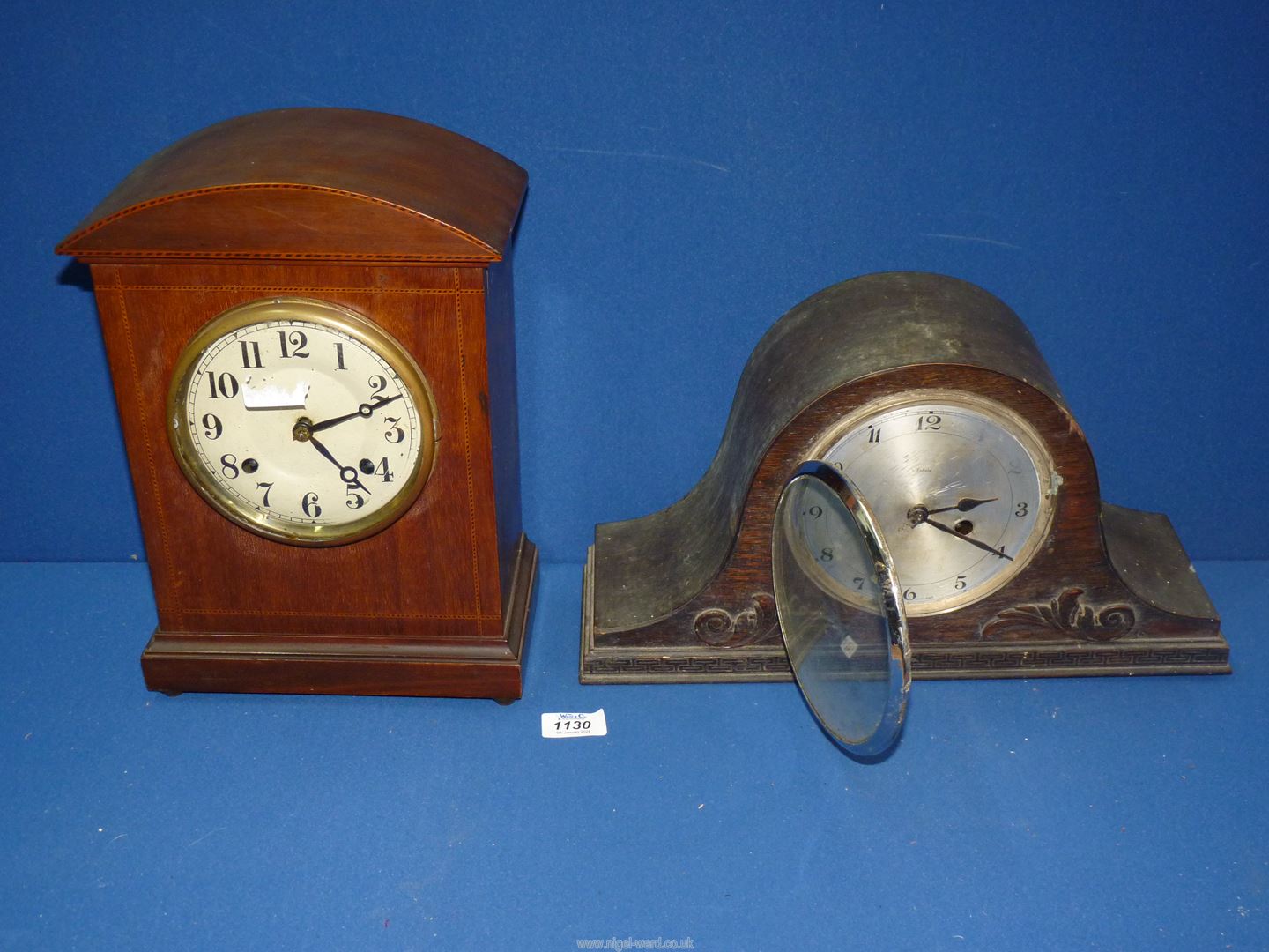 A mantle Clock with Arabic numerals and inlaid detail to the case, with key and pendulum,
