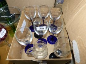 Six blue stemmed wine glasses and two black stemmed ones plus a small jug with pontil.