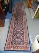 A 'Gumussuyu carpet collection' Wool runner in blue, red and orange with stylised floral design,