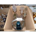 A box of assorted glass decanters and one bottle stand.