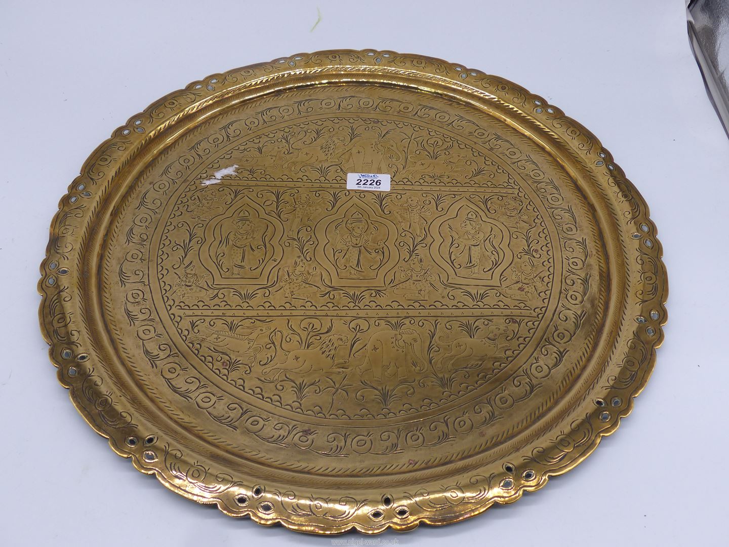 A large brass charger with pierced rims and Eastern style decoration, some bends to the rim, - Image 2 of 2