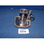 A silver plated chamberstick with detachable snuffer.