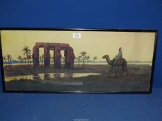 A framed Watercolour of an Egyptian figure riding a camel in the desert with an oasis and a