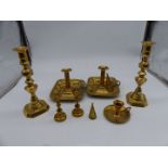 A quantity of candlesticks with pushers and chamber sticks with snuffers.