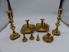 A quantity of candlesticks with pushers and chamber sticks with snuffers.