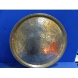 A large brass hand beaten Benares tray with Arabic script and designs, of some age, 23" diameter.