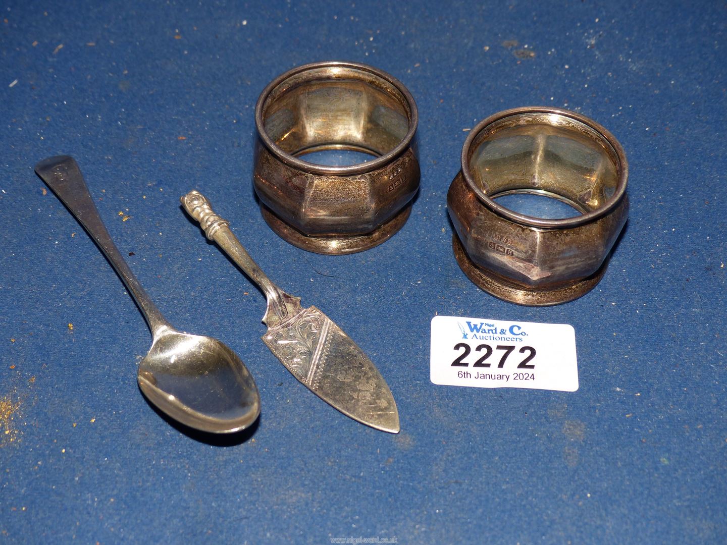 A pair of Silver napkin rings, Birmingham 1926, silver teaspoon and silver miniature cake slice,