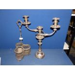 A silver plated candelabra and plated wine bottle stand with acorns and oak leaf design.