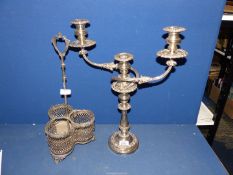 A silver plated candelabra and plated wine bottle stand with acorns and oak leaf design.