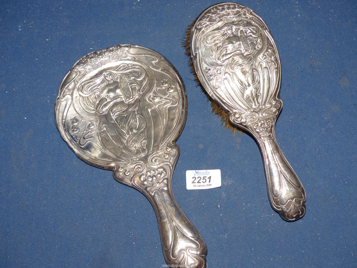 A silver backed Art Nouveau hand Mirror and matched hair brush, Birmingham 1906, some dings. - Image 2 of 2