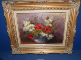An Oil on canvas depicting a bowl of flowers, signed Hemmings.