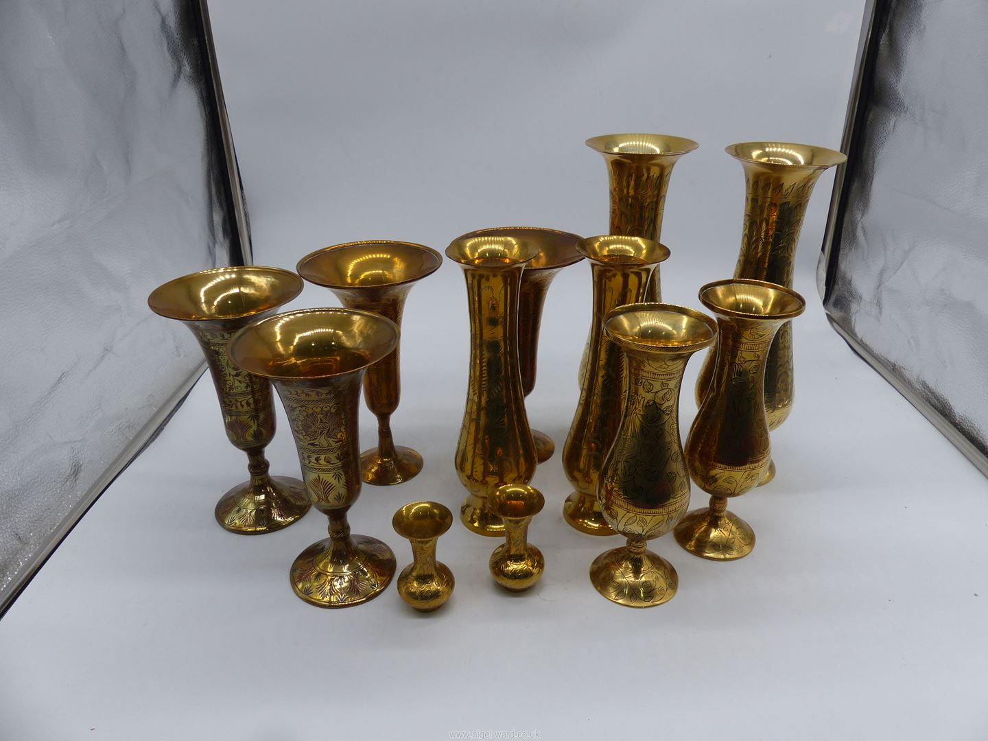 A quantity of brass trumpet vases.