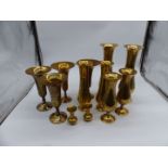 A quantity of brass trumpet vases.