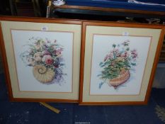 A pair of framed and mounted M. Simandle prints of flower arrangements in shells, 22'' x 24 1/2''.