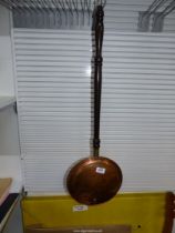 A copper Bed Warming Pan with ebonised handle.