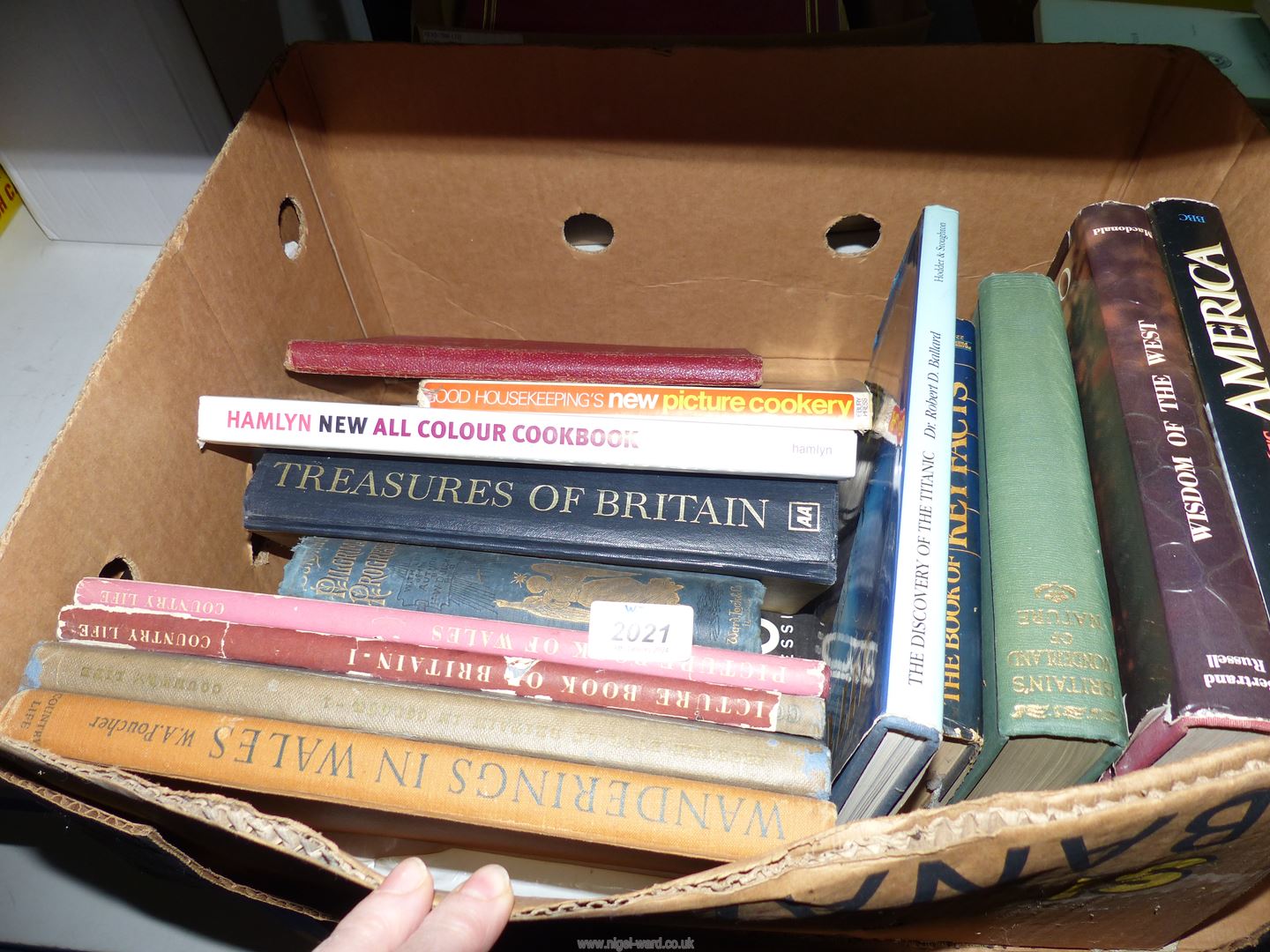 A box of hardback books to include The Discovery of The Titanic, Wandering Wales,