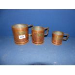 A set of three copper Grain measures, 3", 4" and 4 1/2" tall.