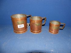 A set of three copper Grain measures, 3", 4" and 4 1/2" tall.