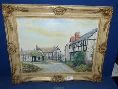 An ornately framed Oil on board of a country village landscape with black and white houses,