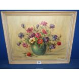 A framed Oil on board of a still life of anemones in a green vase, signed lower right Haselman,