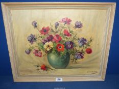 A framed Oil on board of a still life of anemones in a green vase, signed lower right Haselman,